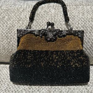 Black and copper beaded evening bag with metal flower detailing